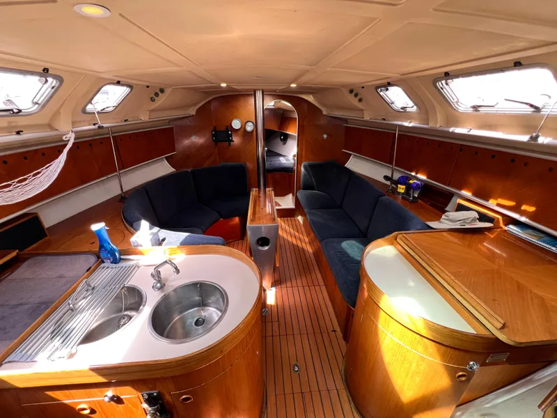 Slide: The Image of Interior of 1990 Beneteau First 41s5 sailboat with wood finish and modern amenities. - 28