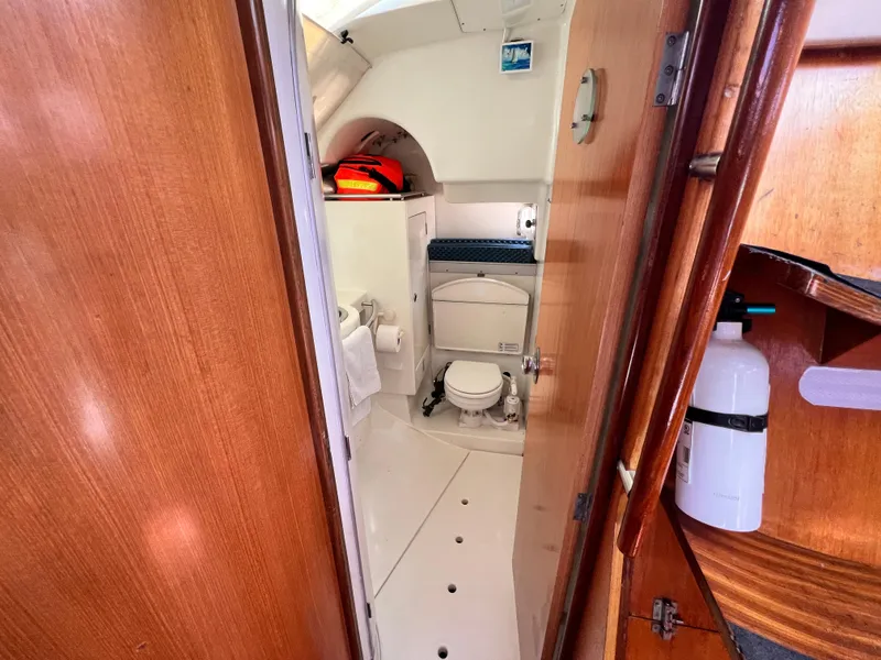 Slide: The Image of Interior of 1990 Beneteau First 41s5 sailboat bathroom with wooden accents and compact design. - 32