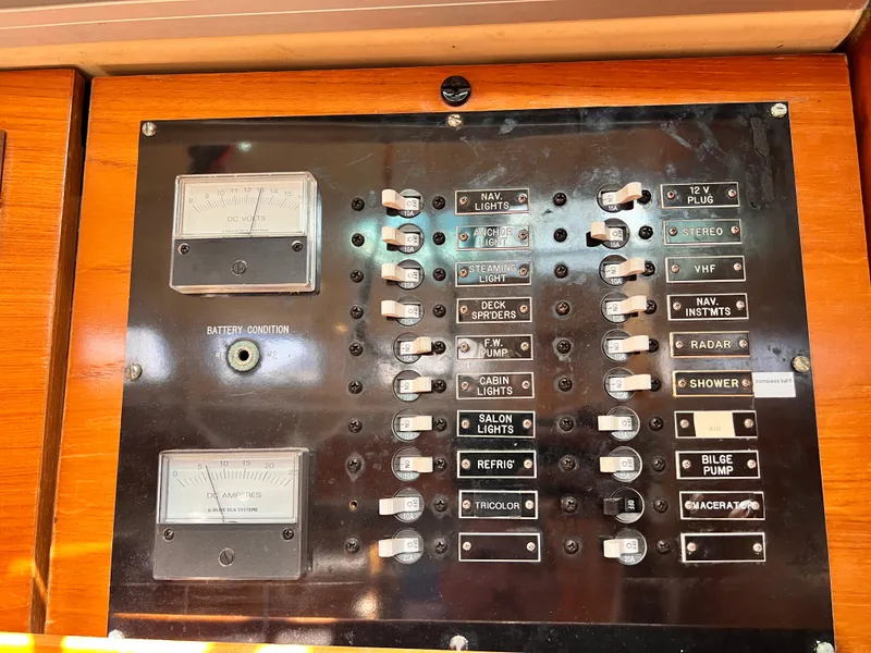 Slide: The Image of Electrical control panel on a 1990 Beneteau First 41s5 sailboat, featuring switches and gauges. - 34