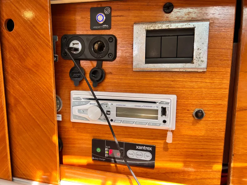 Slide: The Image of Control panel inside a 1990 Beneteau First 41s5 yacht, featuring audio and power systems. - 35