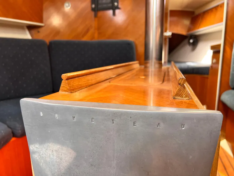 Slide: The Image of Interior of 1990 Beneteau First 41s5 sailboat, featuring polished wood and comfortable seating. - 37