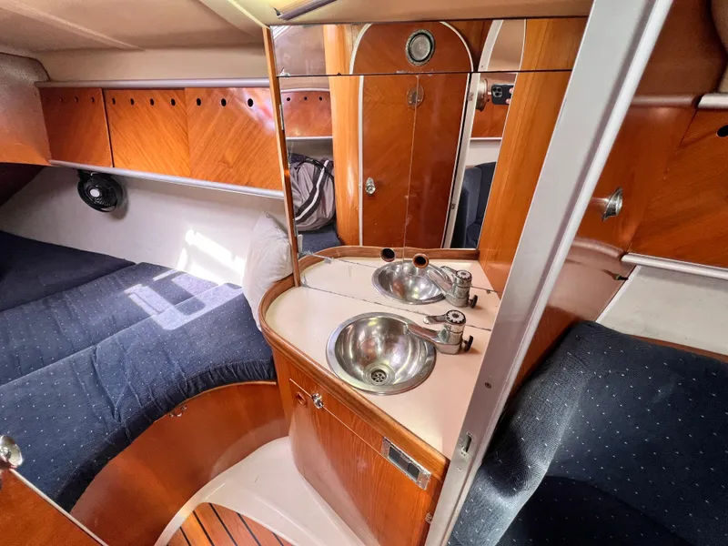Slide: The Image of Interior of 1990 Beneteau First 41s5 yacht with wooden cabinetry and dual sinks. - 42