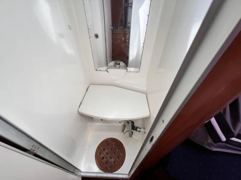 Slide: The Image of Beneteau First 41s5 1990 yacht bathroom with compact shower and wooden drain. - 43