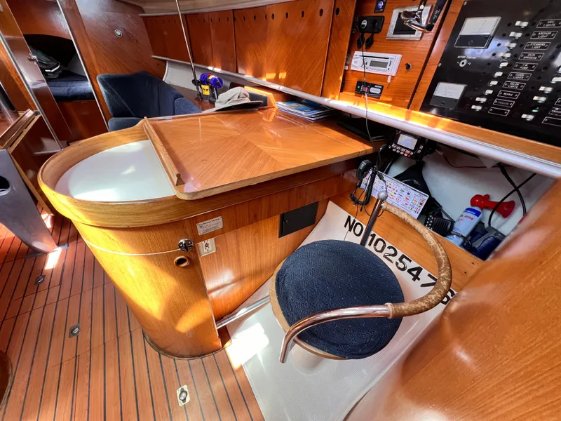 Slide: The Image of Interior of 1990 Beneteau First 41s5 yacht with wooden cabinetry and navigation station. - 6