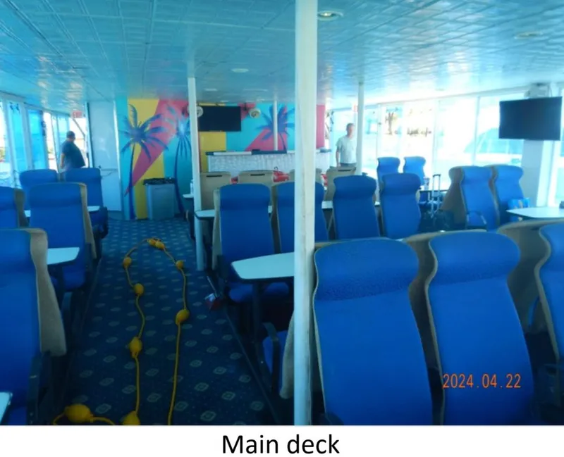 Slide: The Image of Main deck of 2010 Custom Semi Sub Power Catamaran with blue seating and vibrant decor. - 10
