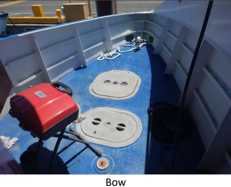 Slide: The Image of Bow of 2010 Custom Semi Sub Power Catamaran with blue deck and equipment. - 12