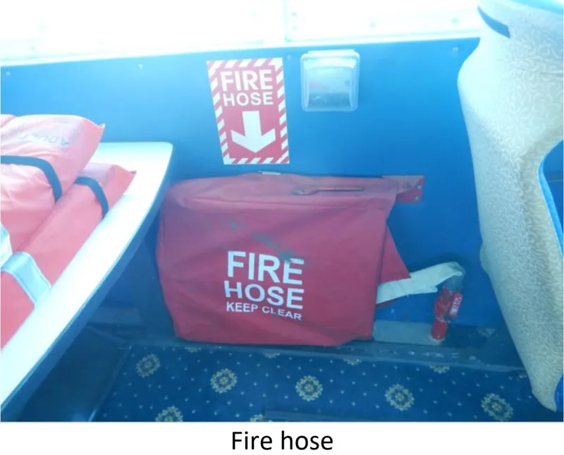 Slide: The Image of Fire hose storage on 2010 Custom Semi Sub Power Catamaran, marked with safety signage. - 15