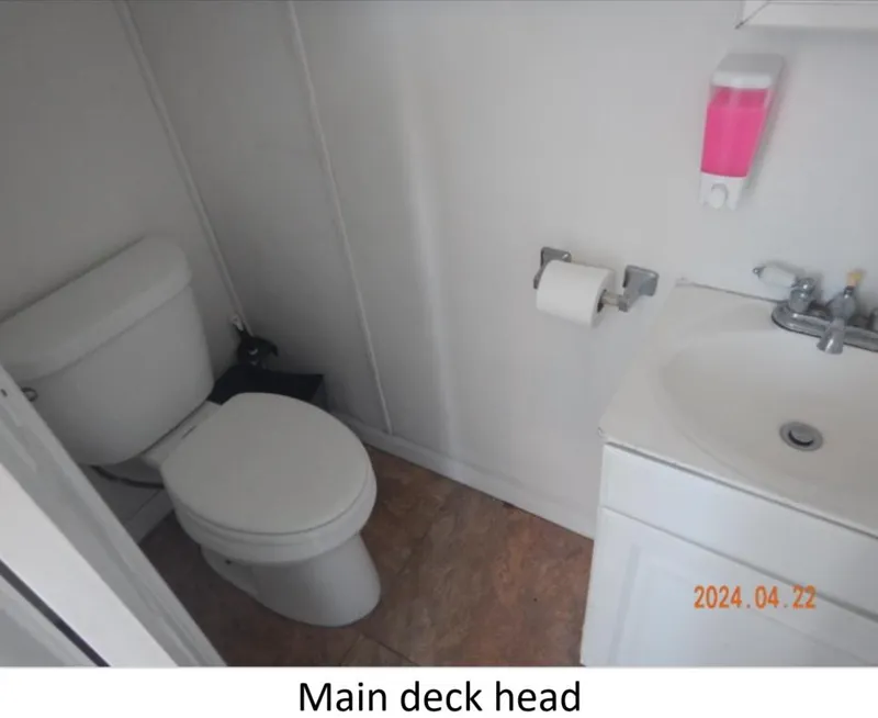 Slide: The Image of Main deck head with toilet and sink on 2010 Custom Semi Sub Power Catamaran. - 17
