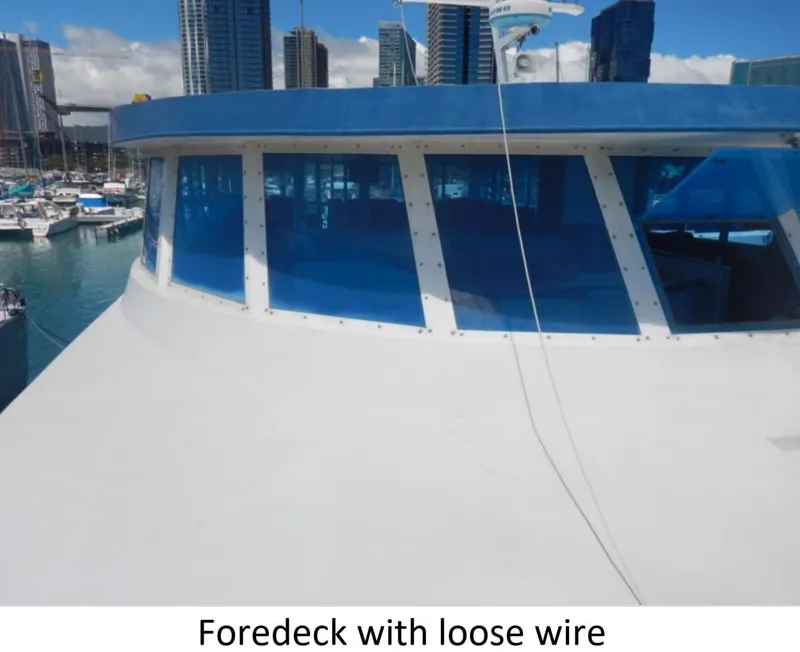 Slide: The Image of Custom 2010 Semi Sub Power Catamaran foredeck with loose wire, city skyline in background. - 4