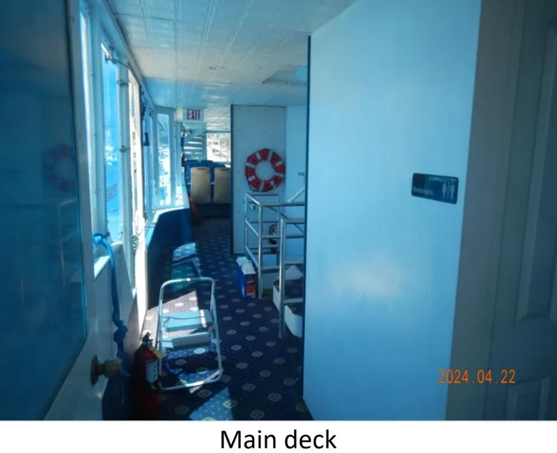 Slide: The Image of Main deck of 2010 Custom Semi Sub Power Catamaran with safety equipment and seating. - 7