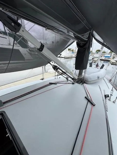 Slide: The Image of 1985 Farr PERFORMANCE sailboat deck with rigging and marina view. - 12