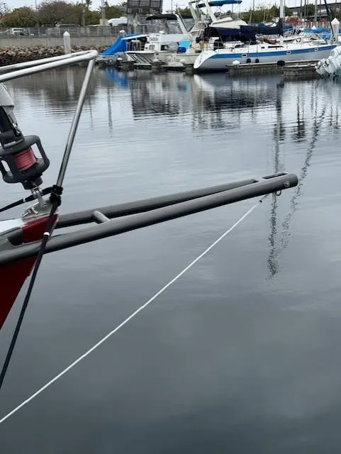 Slide: The Image of Sailboat bow with rigging in a marina, featuring a Farr PERFORMANCE 1985 model. - 13