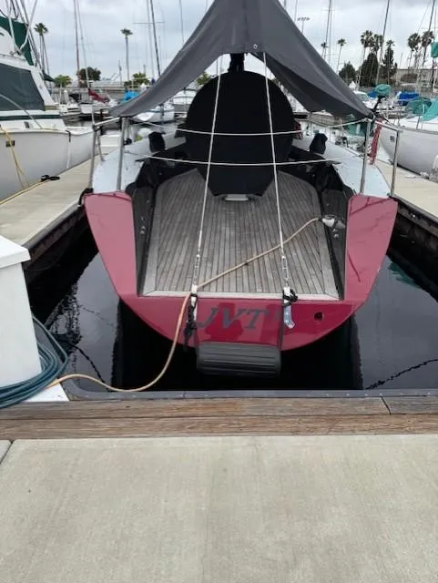 Slide: The Image of 1985 Farr PERFORMANCE sailboat docked, featuring a sleek design and maroon accents. - 15