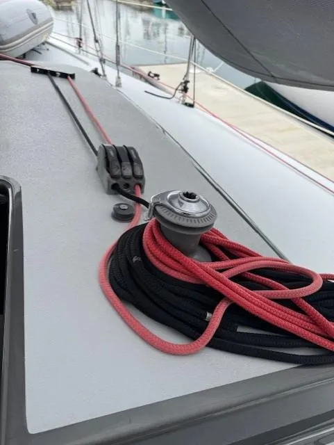 Slide: The Image of 1985 Farr PERFORMANCE sailboat deck with winch and ropes, docked at marina. - 18