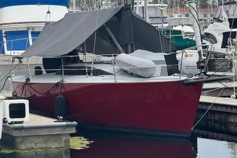 Slide: The Image of Red 1985 Farr PERFORMANCE sailboat docked at marina with tarp cover. - 2