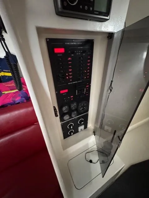 Slide: The Image of Control panel inside 1985 Farr PERFORMANCE boat, featuring gauges and switches. - 21