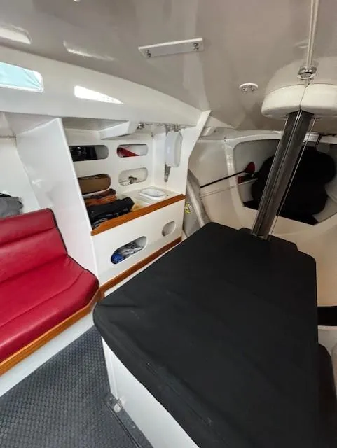 Slide: The Image of Interior of 1985 Farr PERFORMANCE sailboat with red seating and storage compartments. - 23