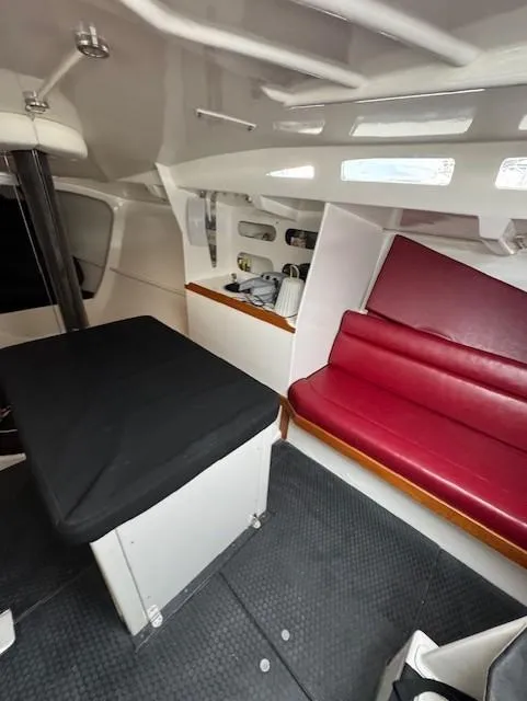 Slide: The Image of Interior of a 1985 Farr Performance boat with red seating and modern design. - 24