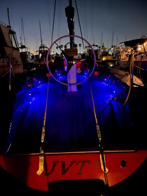 Slide: The Image of Sailboat docked at night with blue deck lights, Farr PERFORMANCE 1985 model. - 37