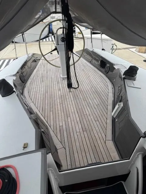 Slide: The Image of 1985 Farr PERFORMANCE sailboat with wooden deck and steering wheel, docked at marina. - 8