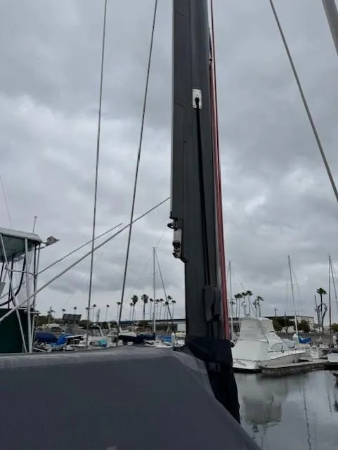 Slide: The Image of Sailboat mast in marina, cloudy sky; 1985 Farr PERFORMANCE model. - 9