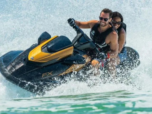 Slide: The Image of 2024 Yamaha Waverunner FX Limited SVHO with audio system, two riders enjoying a thrilling water ride. - 2
