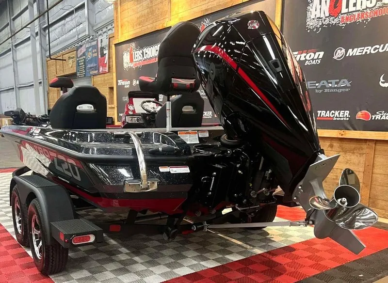 Slide: The Image of 2025 Nitro Z20 XL Pro boat with powerful engine, displayed indoors on checkered flooring. - 2