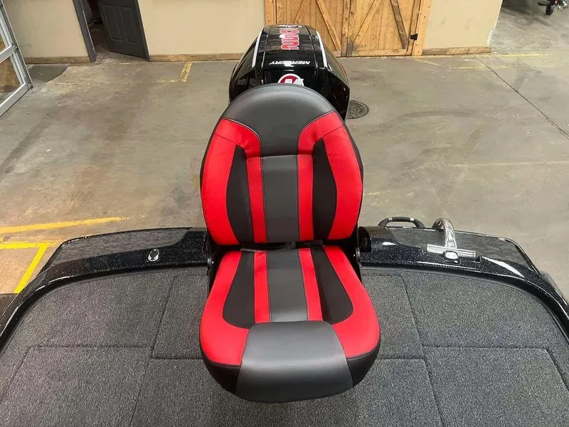 Slide: The Image of Red and black seat on 2025 Nitro Z20 XL Pro boat in a garage setting. - 9