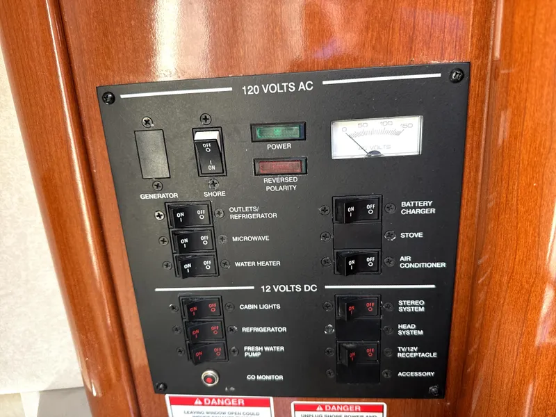 Slide: The Image of Electrical control panel on a 2009 Sea Ray 230 Sundancer boat. - 11