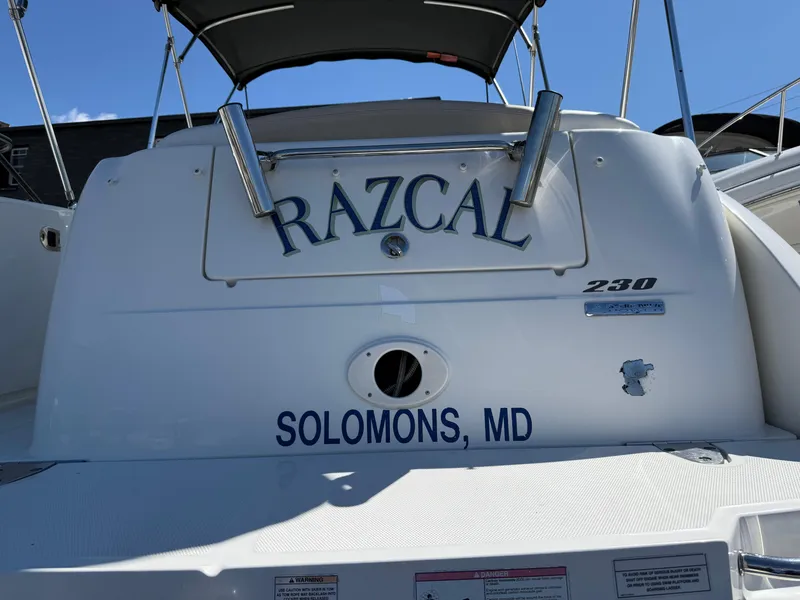 Slide: The Image of 2009 Sea Ray 230 Sundancer boat with "RAZCAL" name, docked in Solomons, MD. - 15