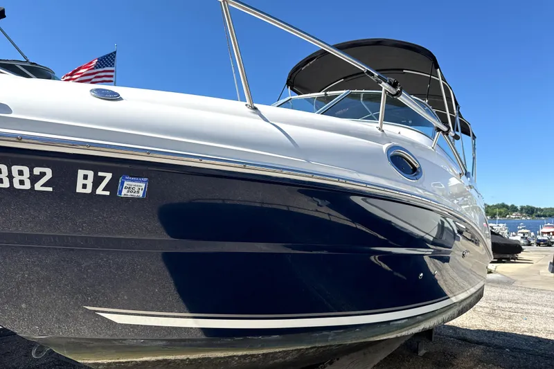 Slide: The Image of 2009 Sea Ray 230 Sundancer boat docked with American flag in background. - 17
