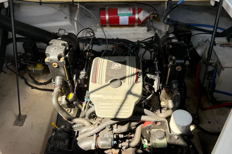 Slide: The Image of Engine compartment of a 2009 Sea Ray 230 Sundancer boat with visible components. - 23