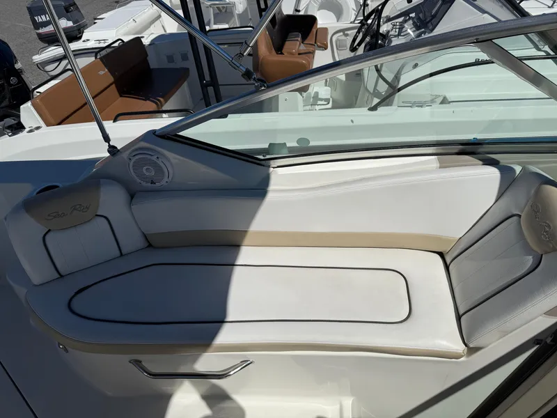 Slide: The Image of 2009 Sea Ray 230 Sundancer boat interior with white seating and glass windshield. - 7