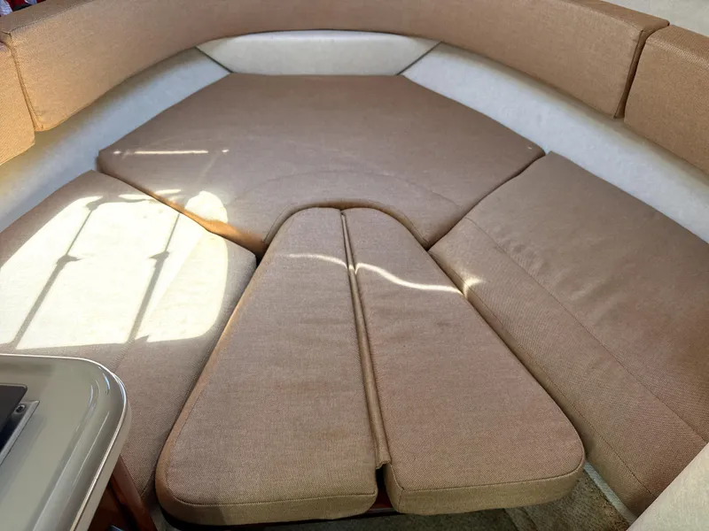 Slide: The Image of Interior view of 2009 Sea Ray 230 Sundancer boat with cushioned seating area. - 9