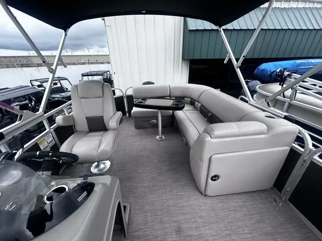 Slide: The Image of 2022 Sun Tracker PARTY BARGE® 20 DLX interior with seating and table, under canopy. - 13