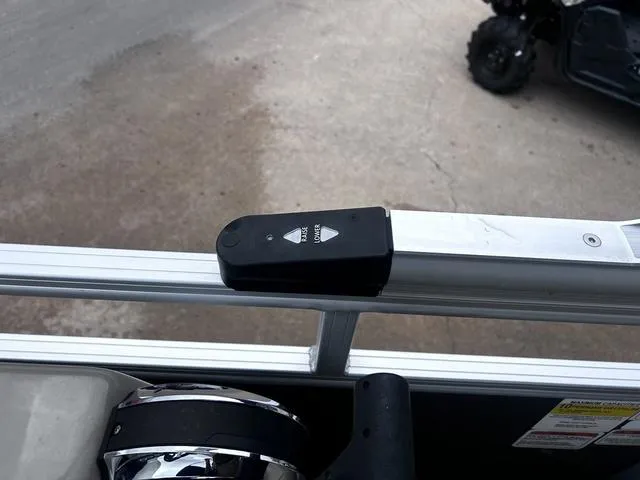 Slide: The Image of 2022 Sun Tracker PARTY BARGE® 20 DLX boat railing with a mounted control device. - 21