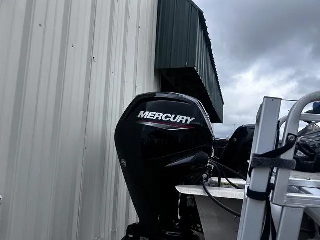 Slide: The Image of Mercury outboard motor on 2022 Sun Tracker PARTY BARGE® 20 DLX, near metal building. - 5
