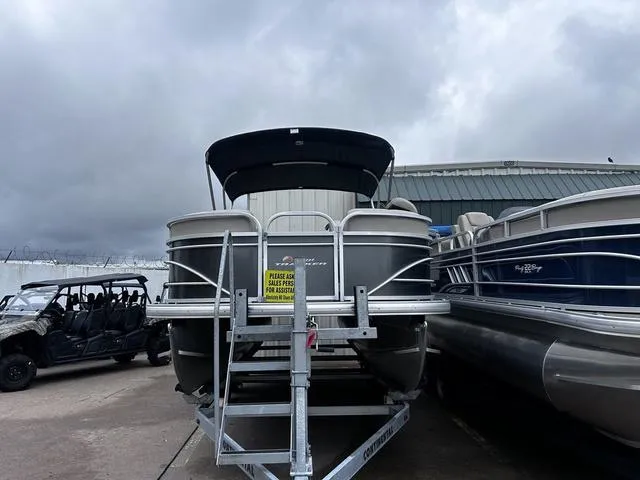 Slide: The Image of 2022 Sun Tracker PARTY BARGE® 20 DLX pontoon boat on trailer, overcast sky. - 8