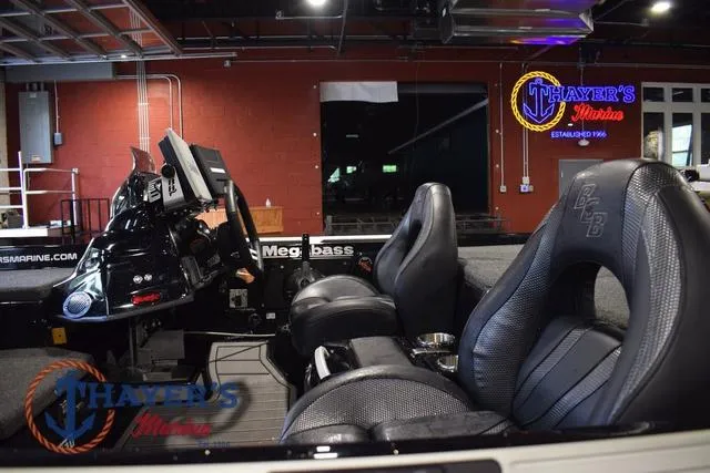 Slide: The Image of 2023 Bass Cat Puma STS boat interior with modern seating and control panel at Thayer's Marine. - 14