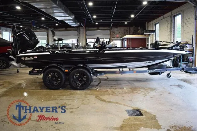 Slide: The Image of 2023 Bass Cat Puma STS boat on trailer in showroom at Thayer's Marine. - 2