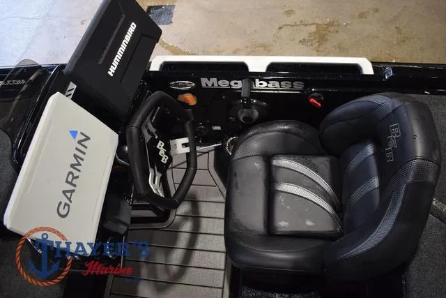 Slide: The Image of 2023 Bass Cat Puma STS boat cockpit with Garmin and Humminbird electronics, black leather seats. - 20