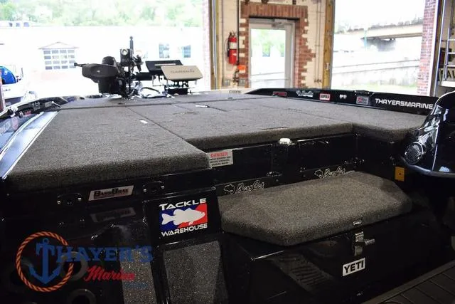 Slide: The Image of 2023 Bass Cat Puma STS boat interior with tackle storage and Yeti cooler. - 26