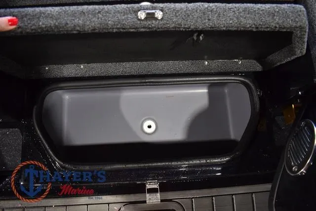 Slide: The Image of 2023 Bass Cat Puma STS storage compartment with open lid, featuring Thayer's Marine logo. - 28