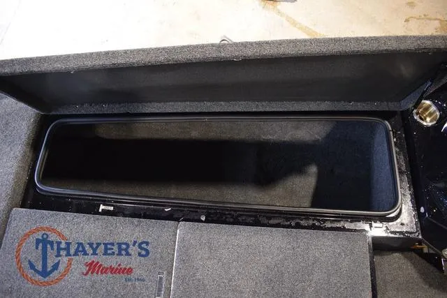 Slide: The Image of 2023 Bass Cat Puma STS storage compartment with Thayer's Marine logo. - 32