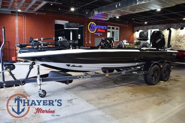 Slide: The Image of 2023 Bass Cat Puma STS boat displayed at Thayer's Marine showroom. - 4