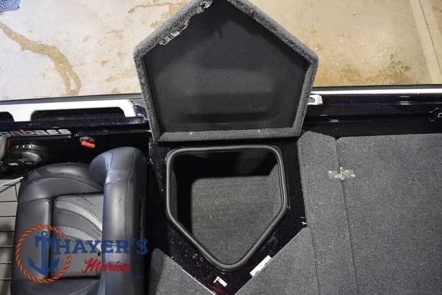 Slide: The Image of 2023 Bass Cat Puma STS boat storage compartment with open lid, showcasing interior space. - 43