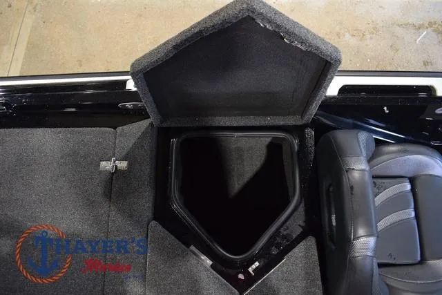 Slide: The Image of 2023 Bass Cat Puma STS boat storage compartment with open lid, showcasing interior space. - 45