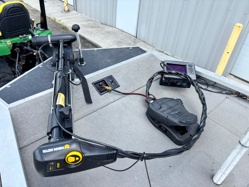 Slide: The Image of 1995 Bass Tracker Pro 18 boat deck with trolling motor and fish finder. - 2