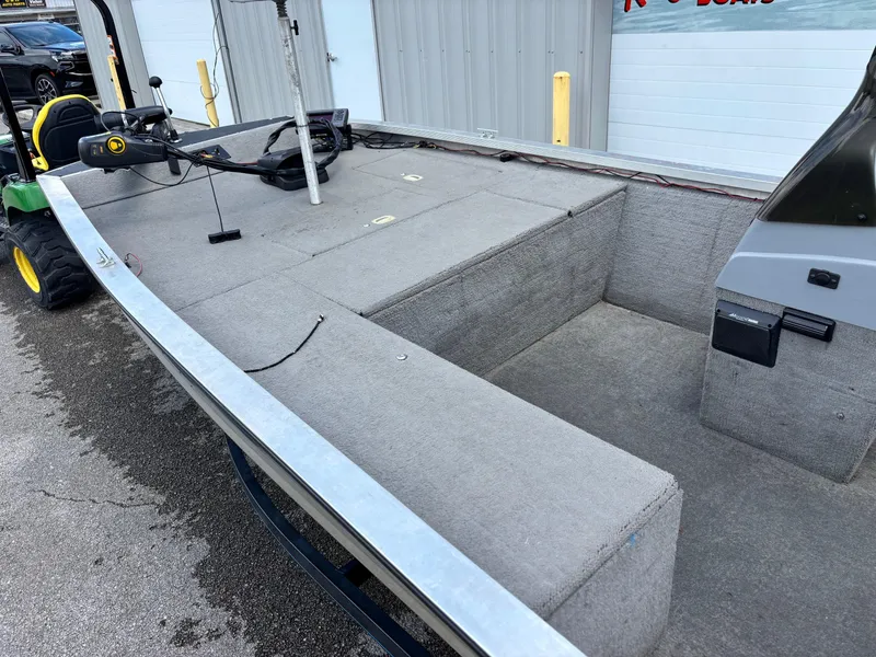 Slide: The Image of 1995 Bass Tracker Pro 18 boat interior with gray carpet and steering console. - 4