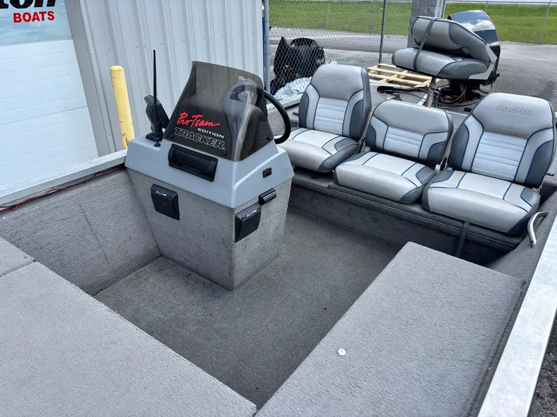 Slide: The Image of 1995 Bass Tracker Pro 18 boat interior with gray seating and steering console. - 5